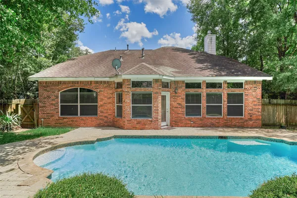 a view of backyard with swimming pool and outdoor seating