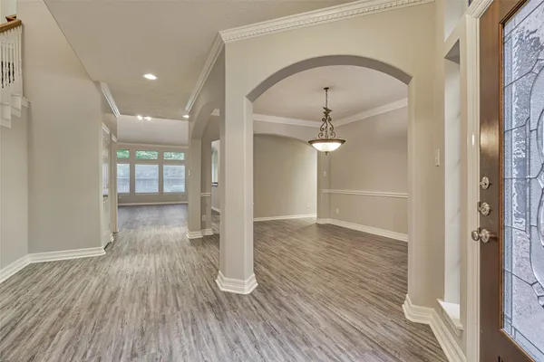a view of empty room with wooden floor