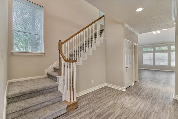 a view of a hallway with wooden floor and entryway
