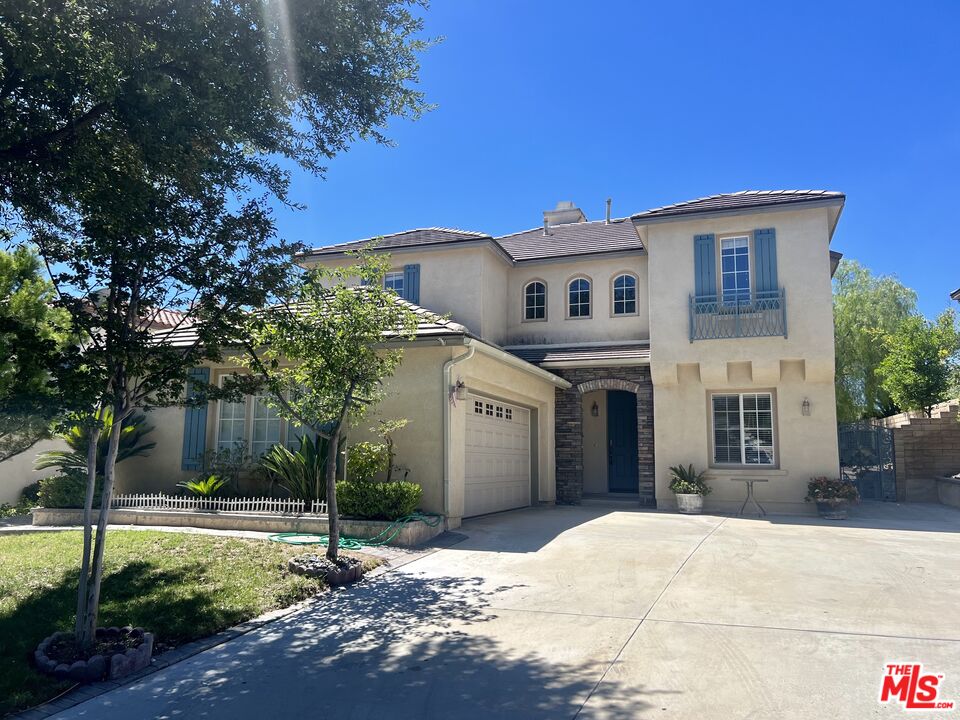 26526 Beecher Lane Stevenson Ranch, CA 91381 - Photo 1 of 31 a front view of a house with a yard and garage