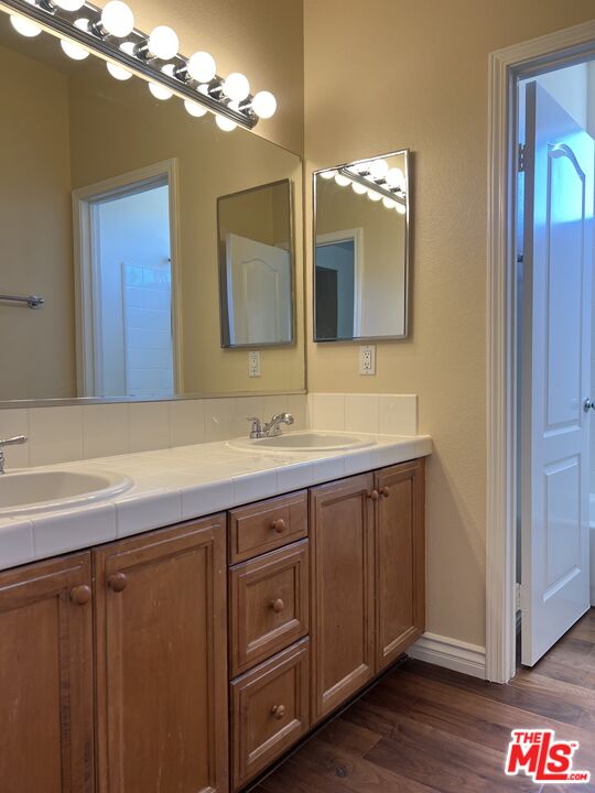 26526 Beecher Lane Stevenson Ranch, CA 91381 - Photo 16 of 31 a bathroom with a double vanity sink and a mirror