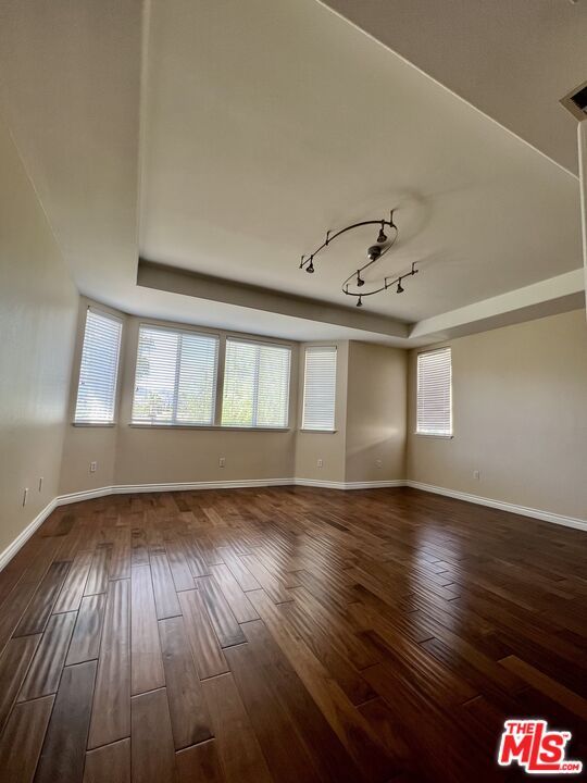 26526 Beecher Lane Stevenson Ranch, CA 91381 - Photo 20 of 31 a view of an empty room with wooden floor and a window