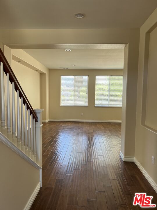 26526 Beecher Lane Stevenson Ranch, CA 91381 - Photo 23 of 31 a view of an empty room with wooden floor and a window