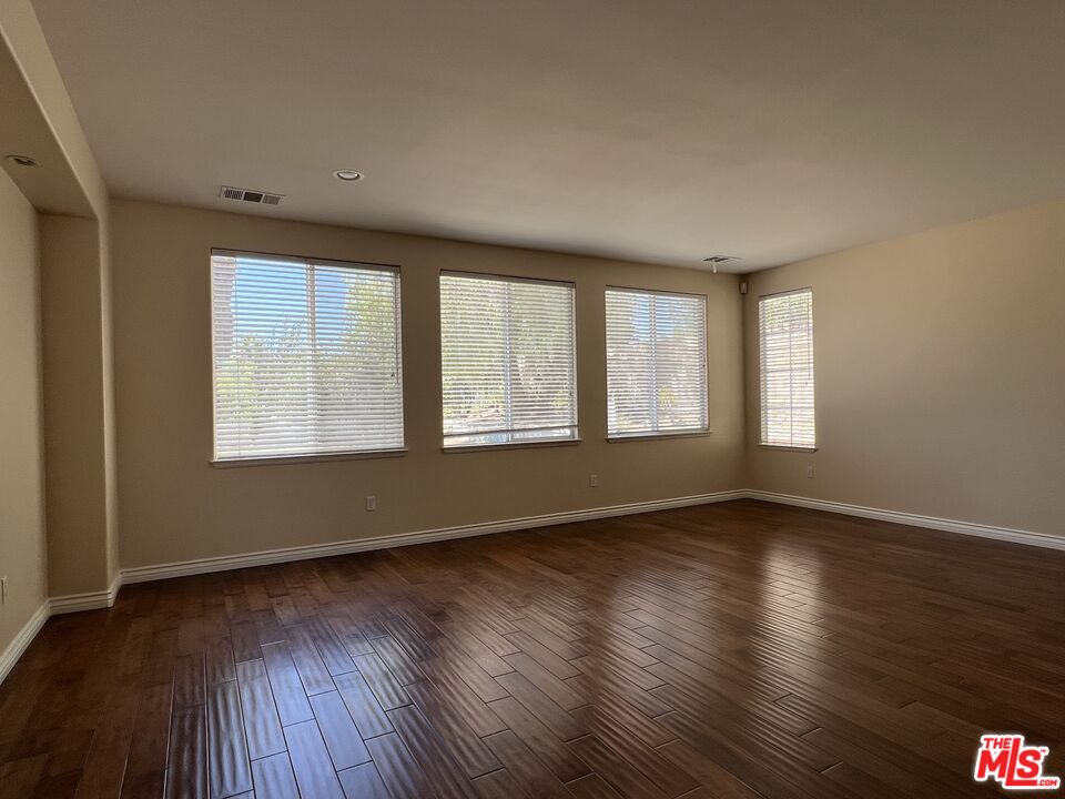 26526 Beecher Lane Stevenson Ranch, CA 91381 - Photo 24 of 31 a view of an empty room with wooden floor and a window