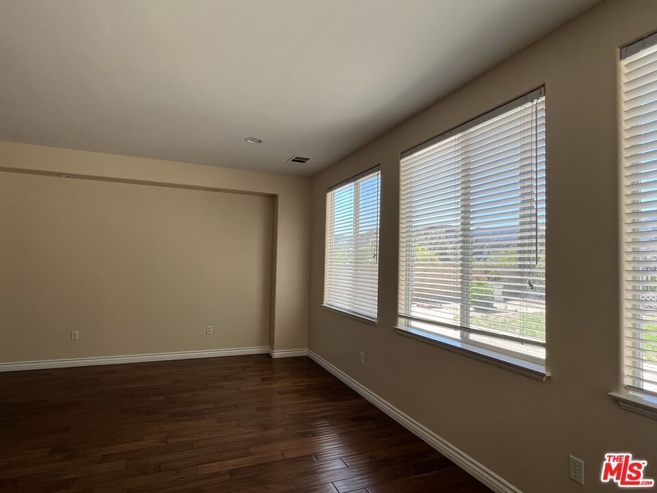 26526 Beecher Lane Stevenson Ranch, CA 91381 - Photo 25 of 31 a view of an empty room with wooden floor and a window