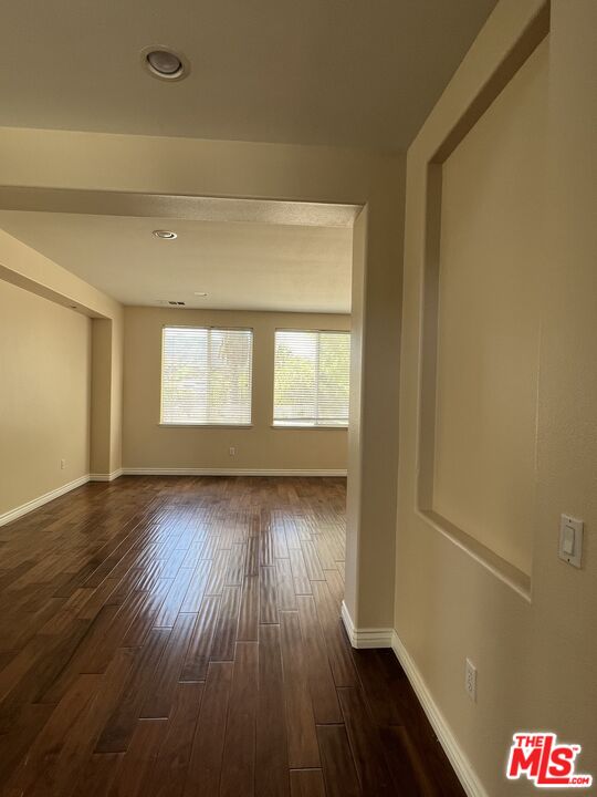 26526 Beecher Lane Stevenson Ranch, CA 91381 - Photo 26 of 31 a view of an empty room with wooden floor and a window