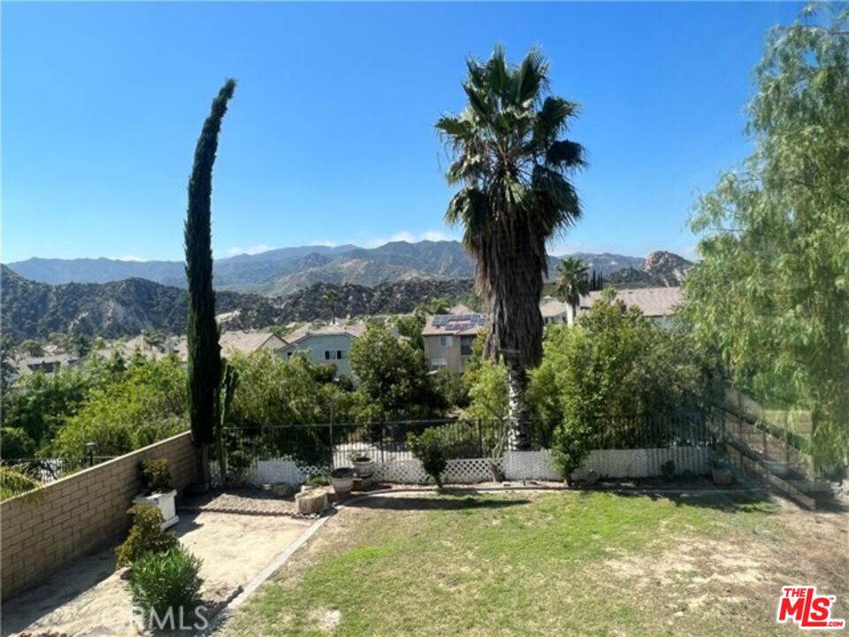 26526 Beecher Lane Stevenson Ranch, CA 91381 - Photo 31 of 31 a view of a swimming pool with a patio and a garden