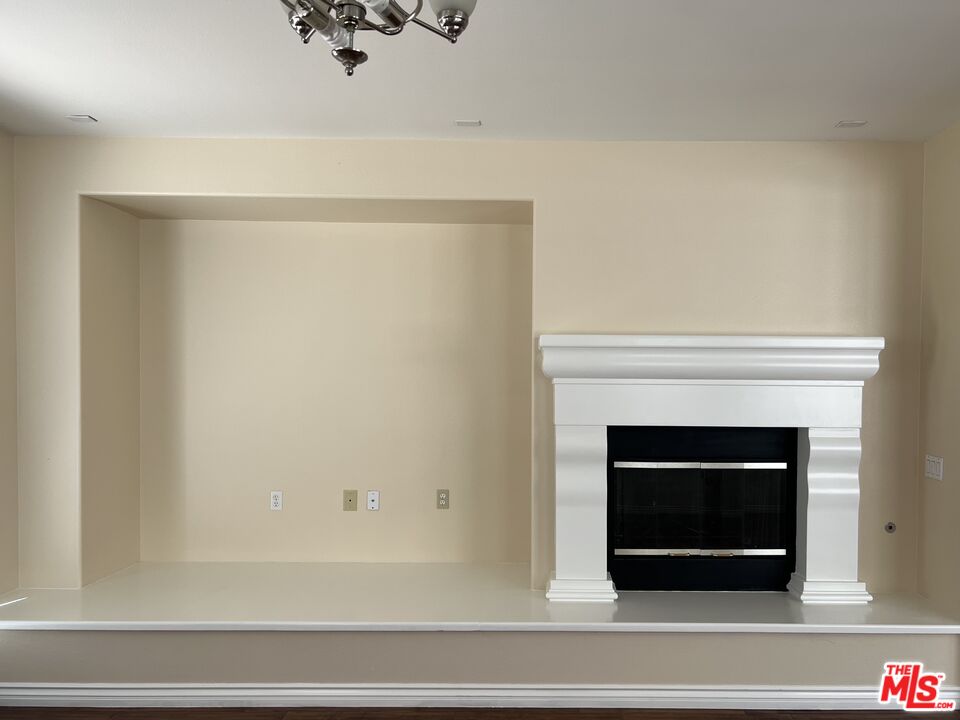 26526 Beecher Lane Stevenson Ranch, CA 91381 - Photo 9 of 31 a white building with a fireplace