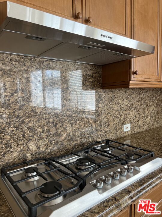 26526 Beecher Lane Stevenson Ranch, CA 91381 - Photo 10 of 31 a stove top oven sitting inside of a kitchen