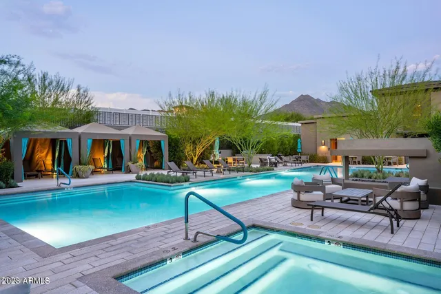 a view of a patio with couches table and chairs and potted plants