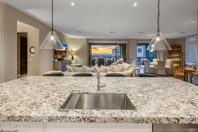 a kitchen with granite countertop a stove and a sink