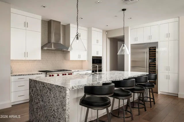 a kitchen with stainless steel appliances granite countertop a sink stove and cabinets