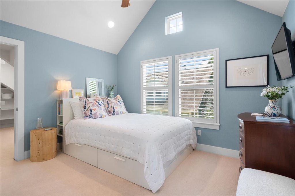 12200 Tawny Farms Road, Unit 139 Austin, TX 78748 - Photo 20 of 30 This second bedroom upstairs is just as charming! It features its own dramatic vaulted ceilings and a gorgeous, soft blue paint color that feels so serene.