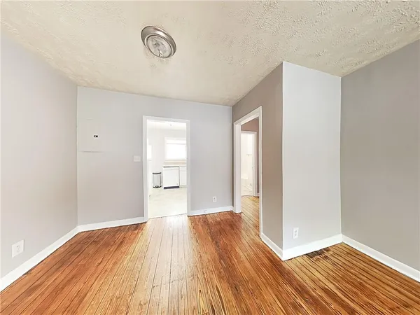 a view of a room with wooden floor and white doors
