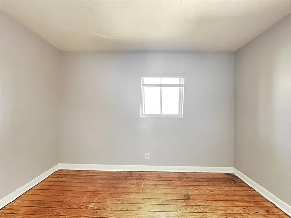 a view of room with wooden floor