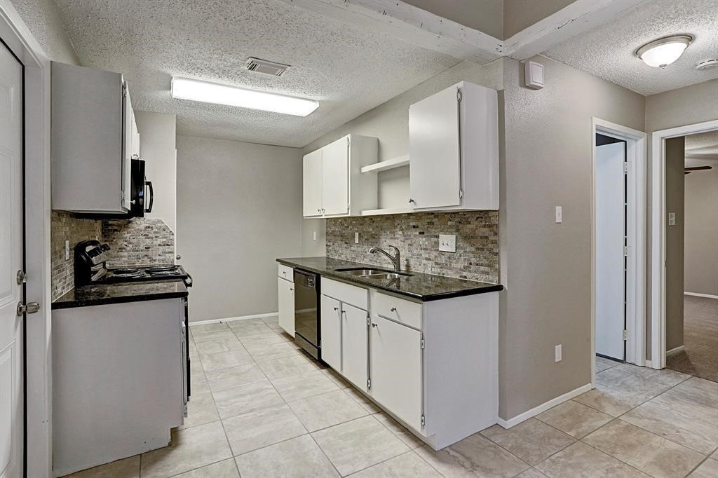 23322 Pebworth Place Spring, TX 77373 - Photo 5 of 10 a kitchen with granite countertop a sink and a stove top oven
