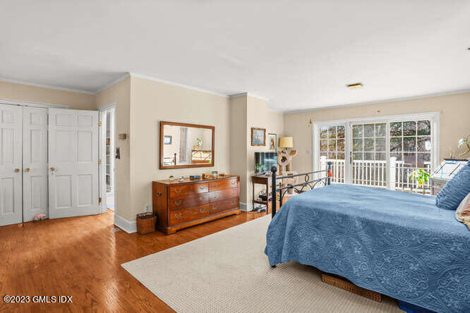 320 Cognewaugh Road Cos Cob, CT 06807 - Photo 13 of 38 a spacious bedroom with a bed and wooden floor
