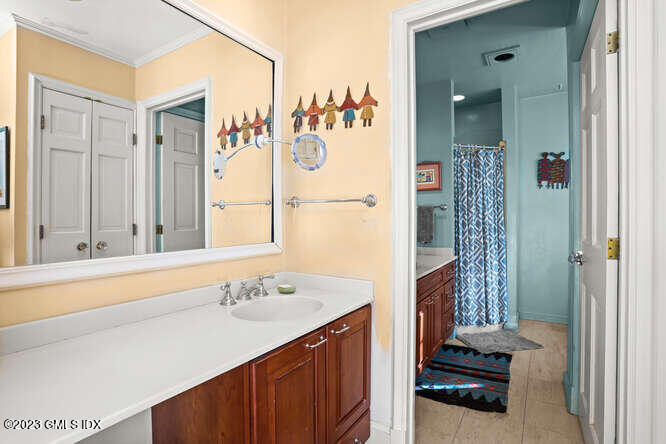320 Cognewaugh Road Cos Cob, CT 06807 - Photo 14 of 38 a bathroom with a sink and a mirror