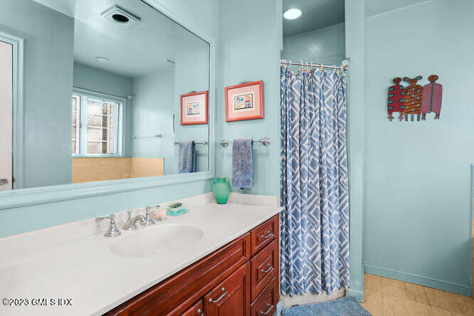 320 Cognewaugh Road Cos Cob, CT 06807 - Photo 15 of 38 a bathroom with a sink and a mirror
