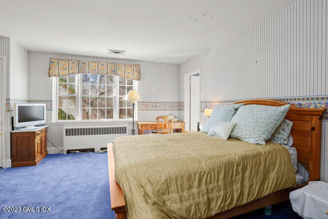 320 Cognewaugh Road Cos Cob, CT 06807 - Photo 16 of 38 a bedroom with a bed and a stove