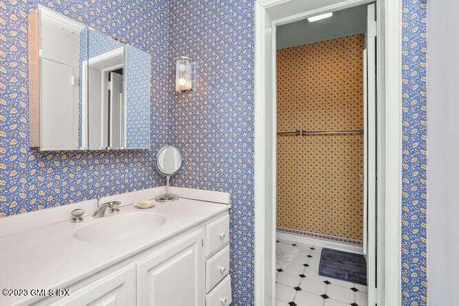 320 Cognewaugh Road Cos Cob, CT 06807 - Photo 17 of 38 a bathroom with a sink and a mirror