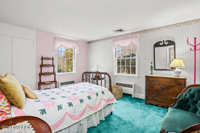 320 Cognewaugh Road Cos Cob, CT 06807 - Photo 18 of 38 a bedroom with a bed next to a window and a lamp