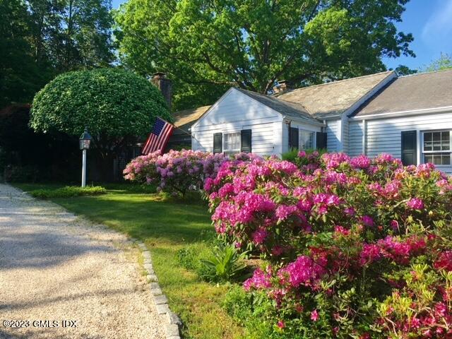 320 Cognewaugh Road Cos Cob, CT 06807 - Photo 23 of 38 a front view of a house with a yard