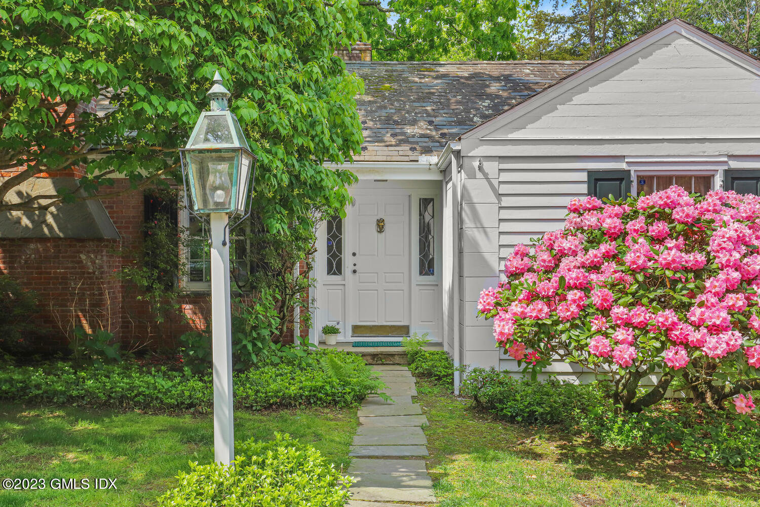 320 Cognewaugh Road Cos Cob, CT 06807 - Photo 26 of 38 a front view of a house with garden