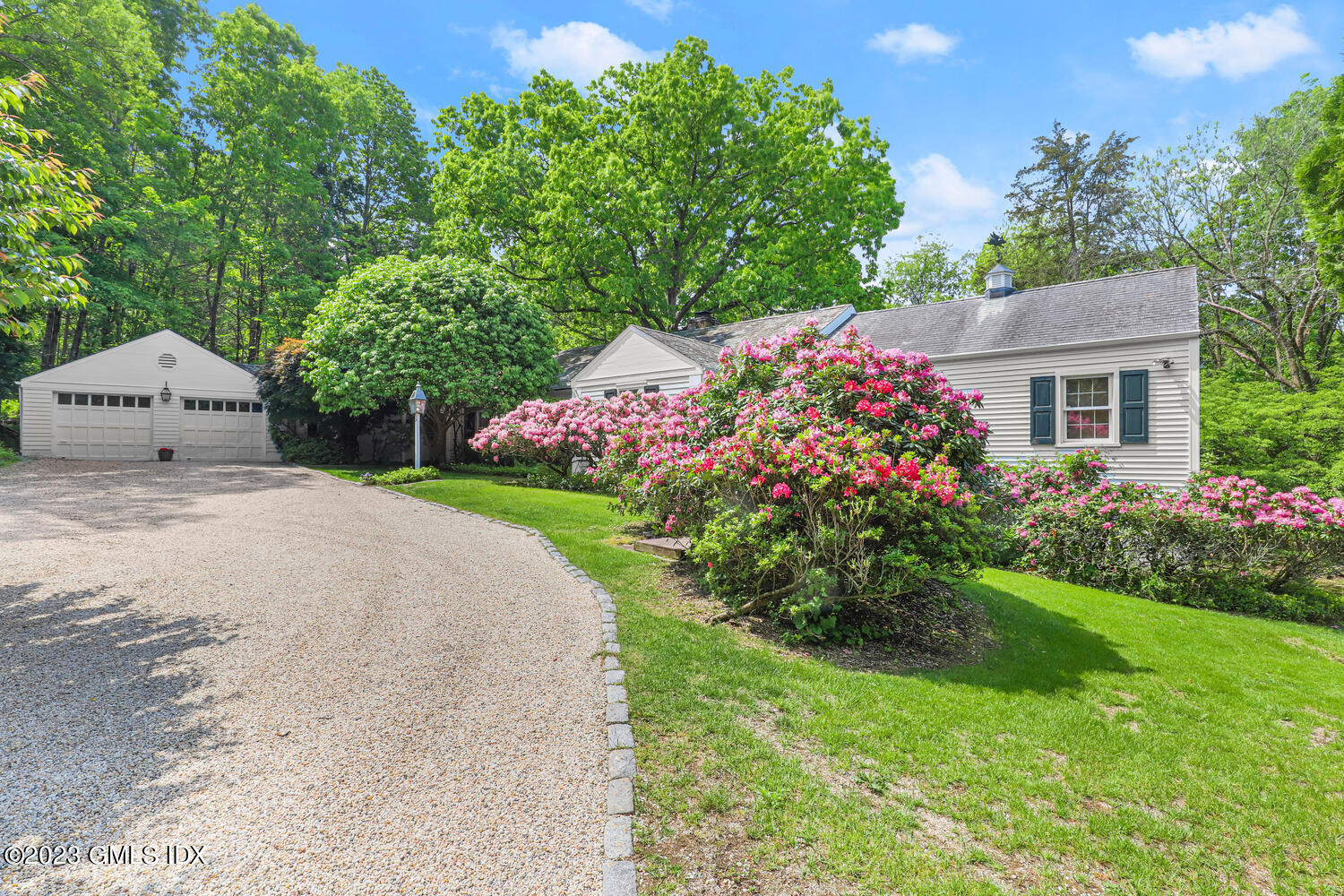 320 Cognewaugh Road Cos Cob, CT 06807 - Photo 28 of 38 a front view of a house with a garden
