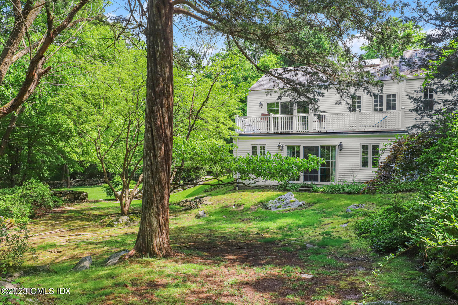 320 Cognewaugh Road Cos Cob, CT 06807 - Photo 33 of 38 a view of a house with a yard and potted plants