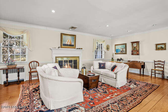 320 Cognewaugh Road Cos Cob, CT 06807 - Photo 4 of 38 a living room with furniture a rug and a fireplace