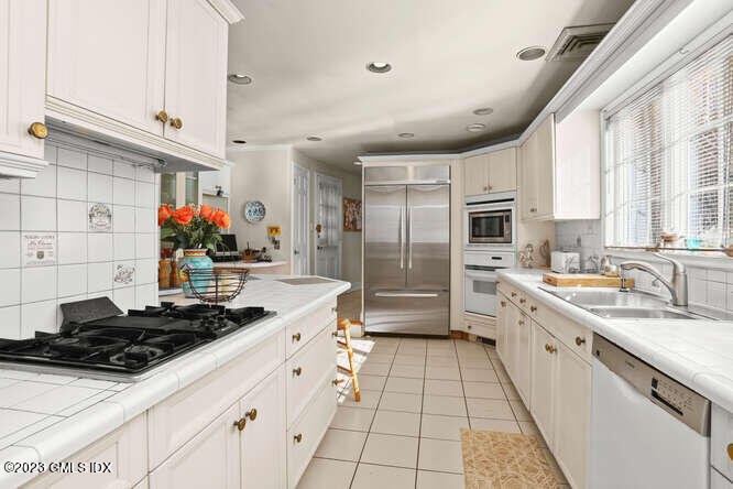320 Cognewaugh Road Cos Cob, CT 06807 - Photo 6 of 38 a kitchen with stainless steel appliances a sink a stove and a refrigerator