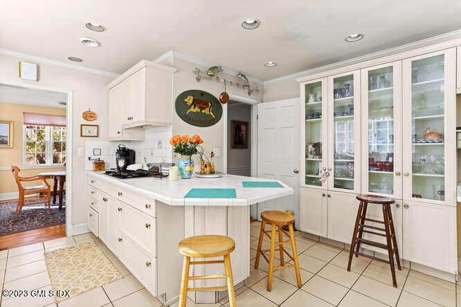 320 Cognewaugh Road Cos Cob, CT 06807 - Photo 8 of 38 a kitchen with a dining table and chairs