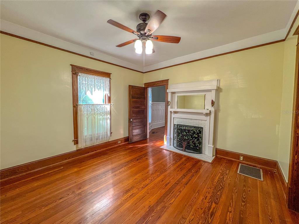 516 Northeast 4 Street Gainesville, FL 32601 - Photo 16 of 57 a view of an empty room with a fireplace and a window