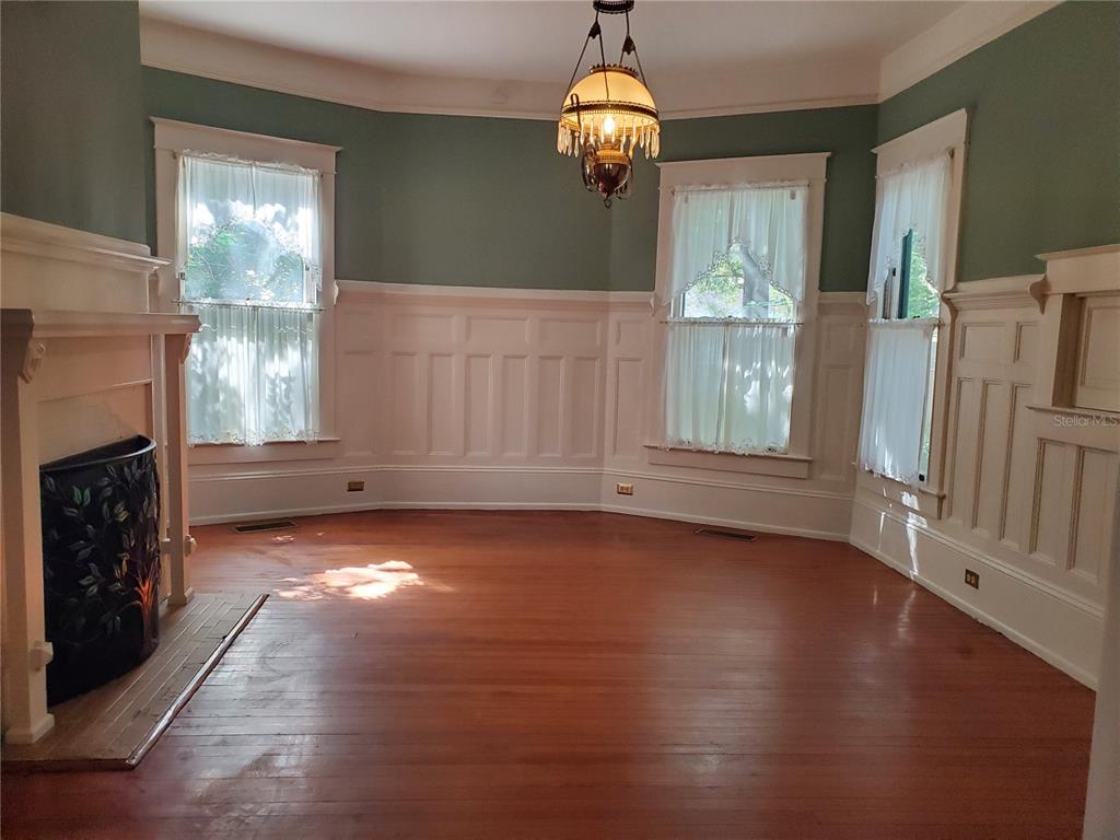 516 Northeast 4 Street Gainesville, FL 32601 - Photo 17 of 57 a view of empty room with wooden floor and fireplace