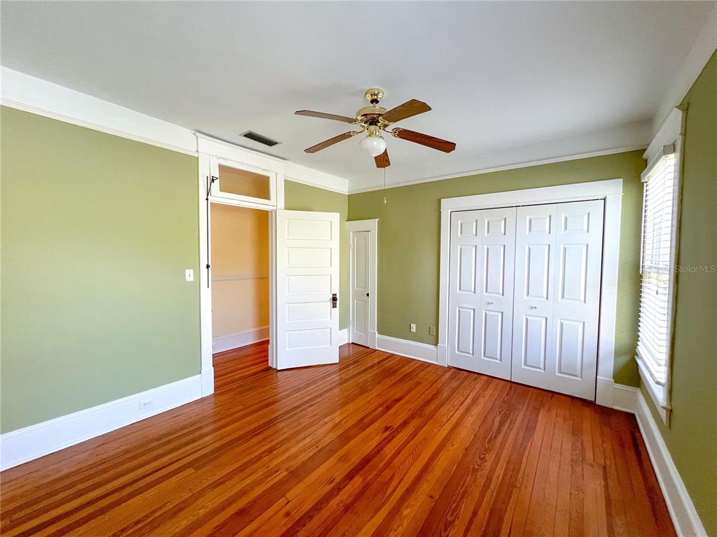 516 Northeast 4 Street Gainesville, FL 32601 - Photo 28 of 57 an empty room with wooden floor and windows