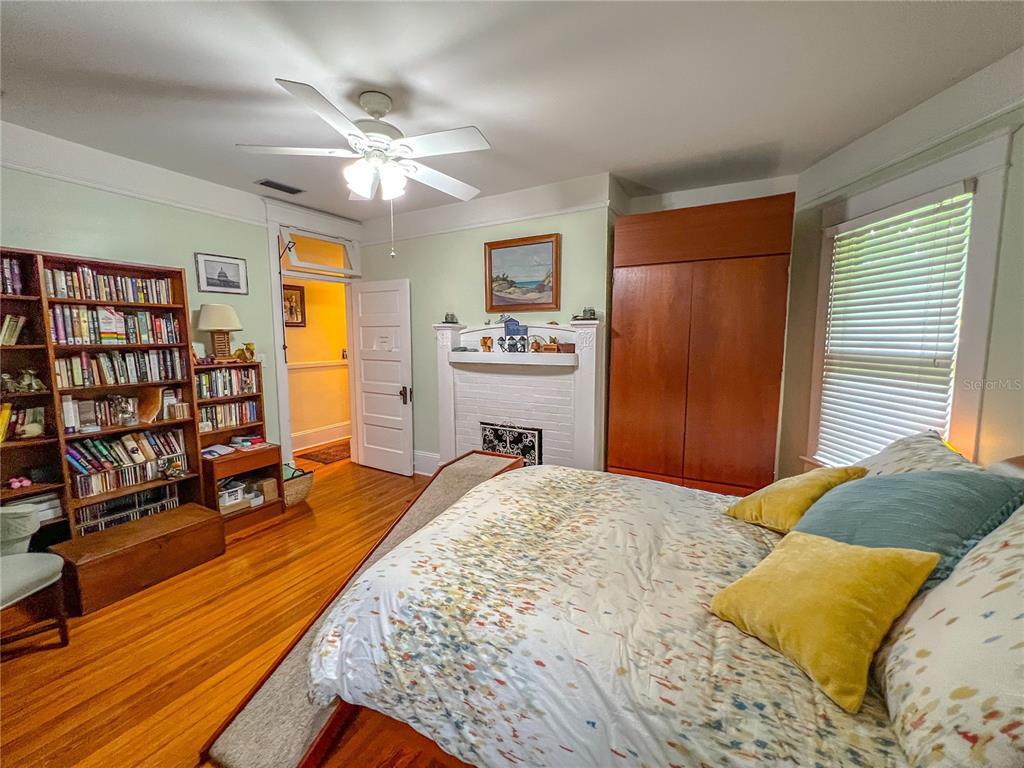 516 Northeast 4 Street Gainesville, FL 32601 - Photo 29 of 57 a bedroom with a bed and wooden floor