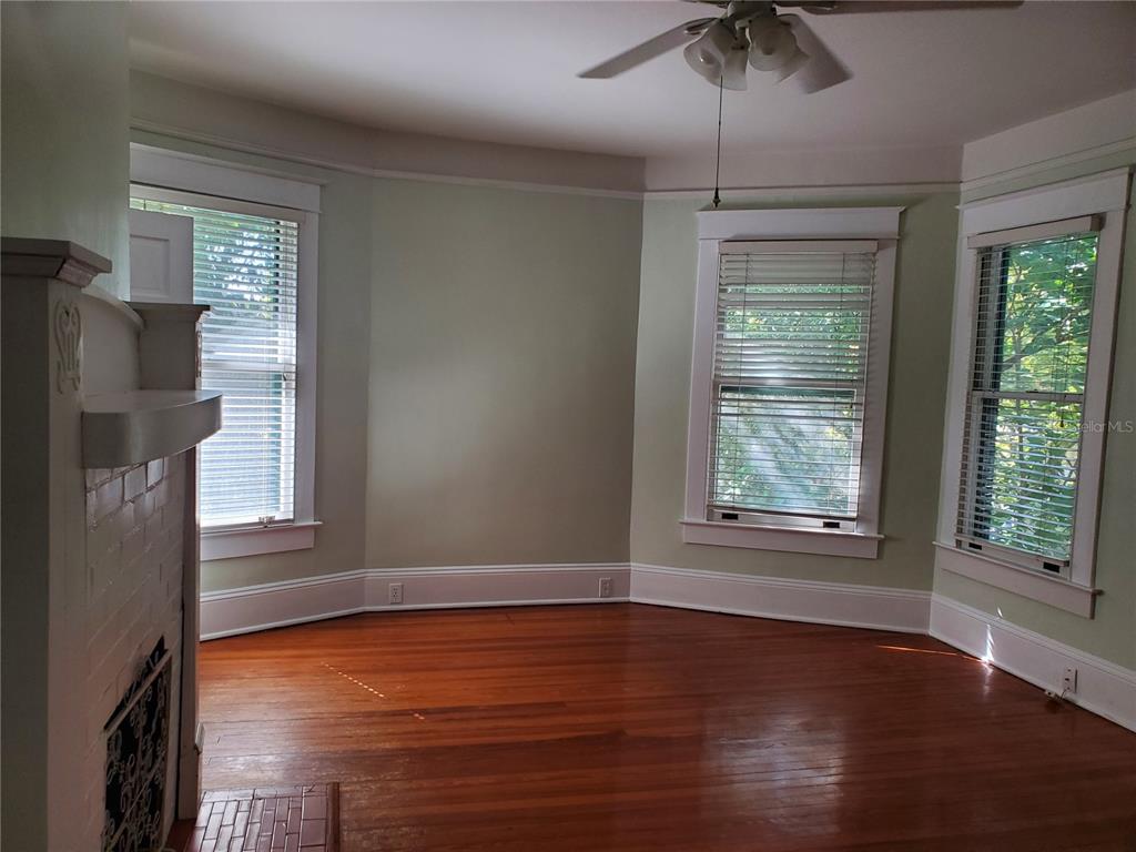 516 Northeast 4 Street Gainesville, FL 32601 - Photo 32 of 57 a view of an empty room with wooden floor and a window