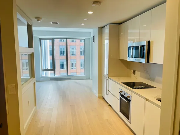 a kitchen with stainless steel appliances granite countertop a stove and a refrigerator