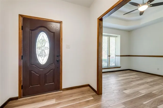 a view of an entryway with wooden floor