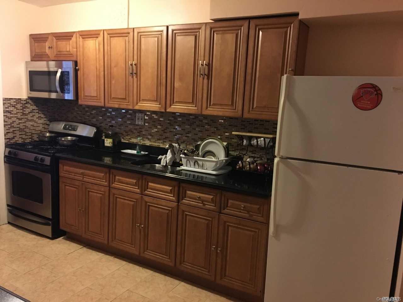 58-17 Van Cleef Street Queens, NY 11368 - Photo 3 of 6 a kitchen with stainless steel appliances granite countertop a refrigerator a stove a sink and dishwasher