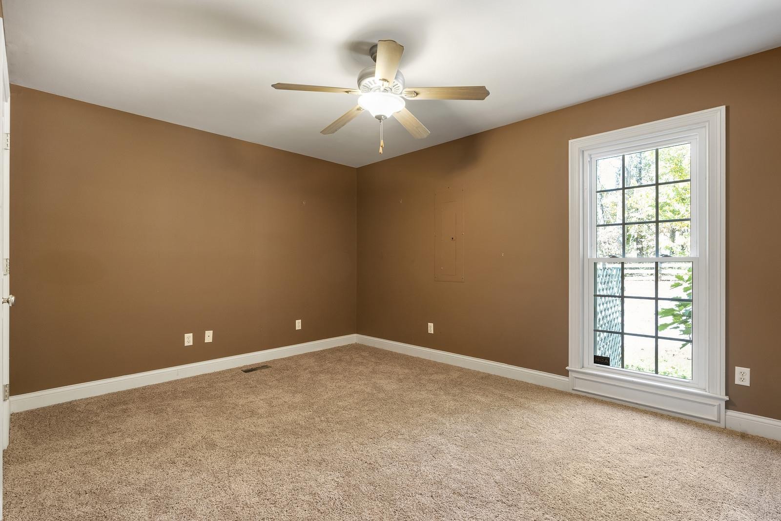 7205 Highland Road Portland, TN 37148 - Photo 18 of 29 an empty room with windows and chandelier fan