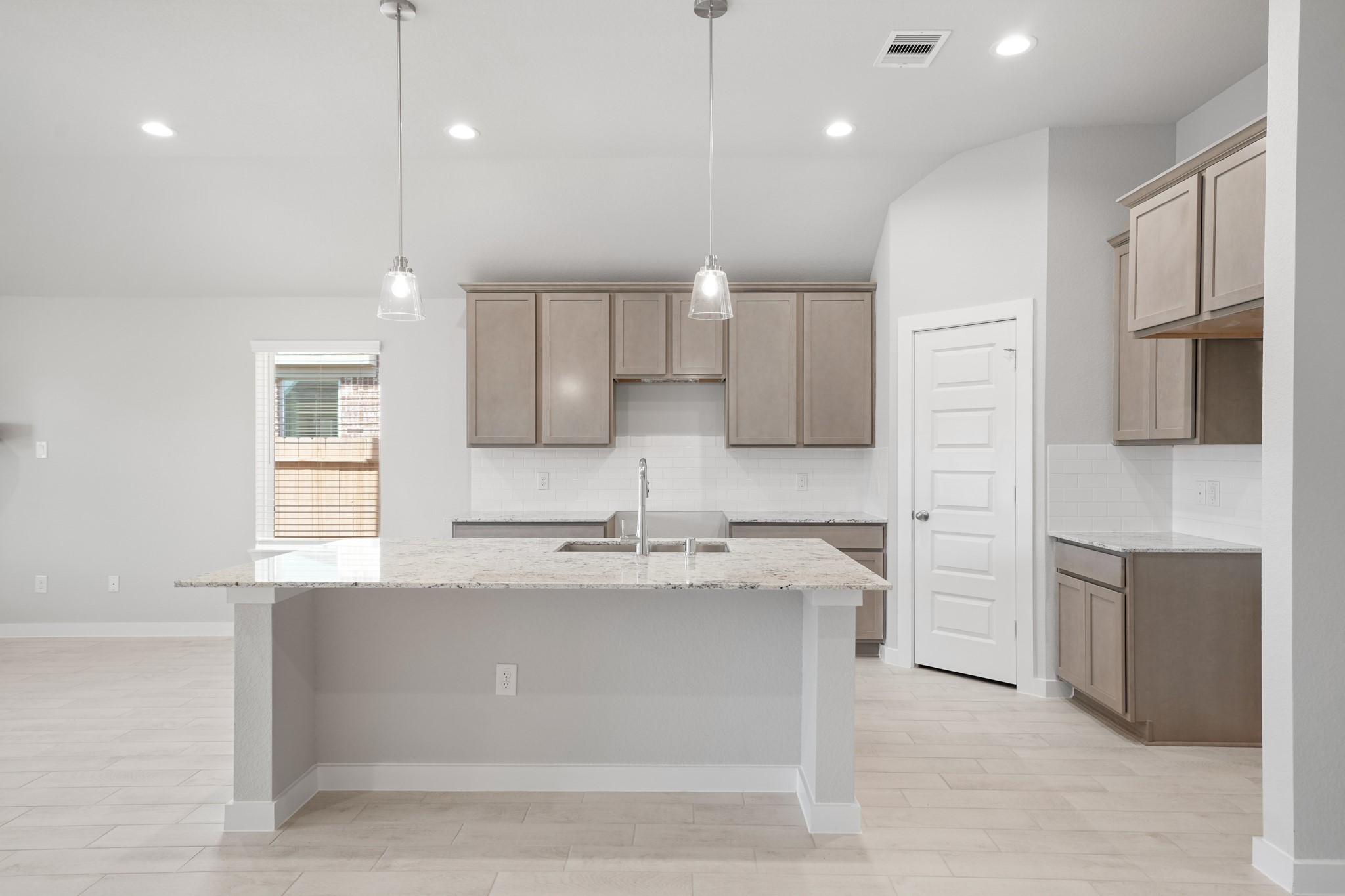 44 Shining Pt Drive Waller, TX 77484 - Photo 3 of 36 a large kitchen with stainless steel appliances kitchen island granite countertop a stove a sink and a refrigerator
