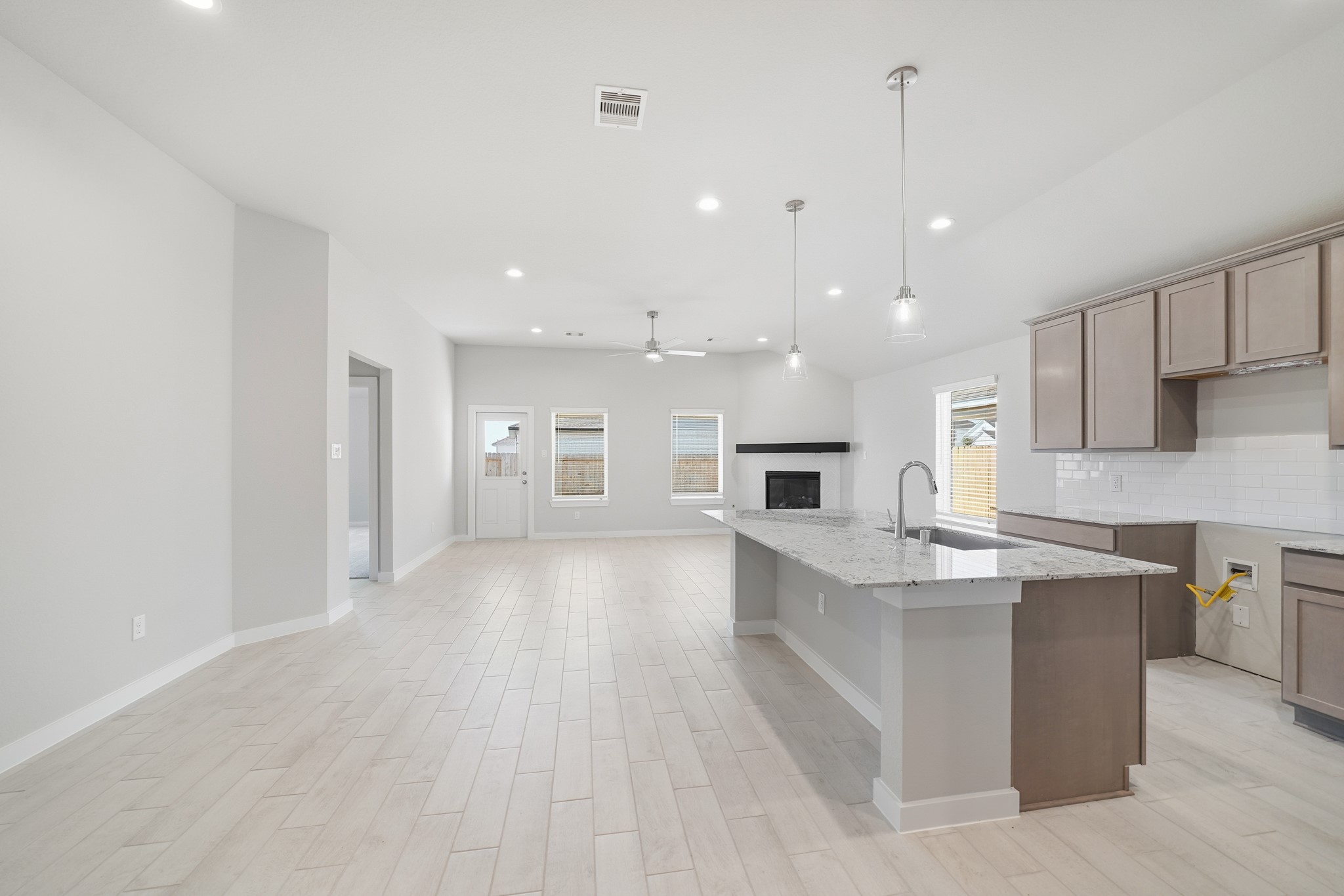 44 Shining Pt Drive Waller, TX 77484 - Photo 5 of 36 a large kitchen with kitchen island a sink dishwasher a stove and a refrigerator with wooden floor