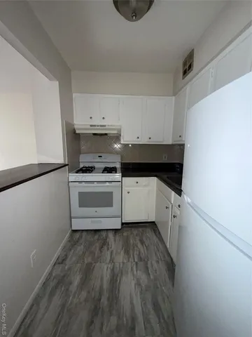 a kitchen with a sink and a stove top oven