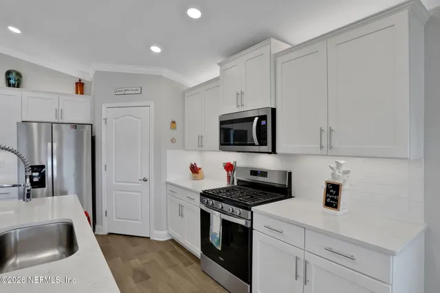a kitchen with microwave and stove