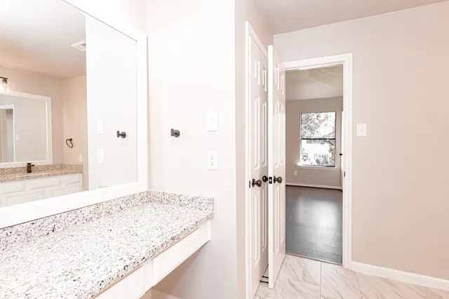 a view of a bathroom from a hallway