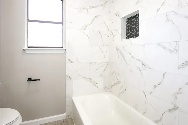 a bathroom with a bathtub and shower