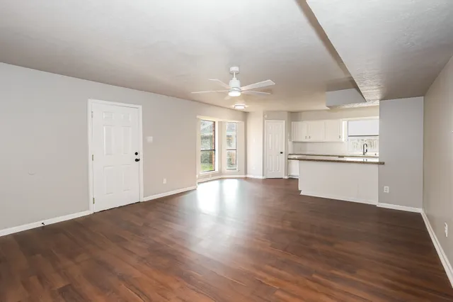 a view of a kitchen with wooden floor and a kitchen