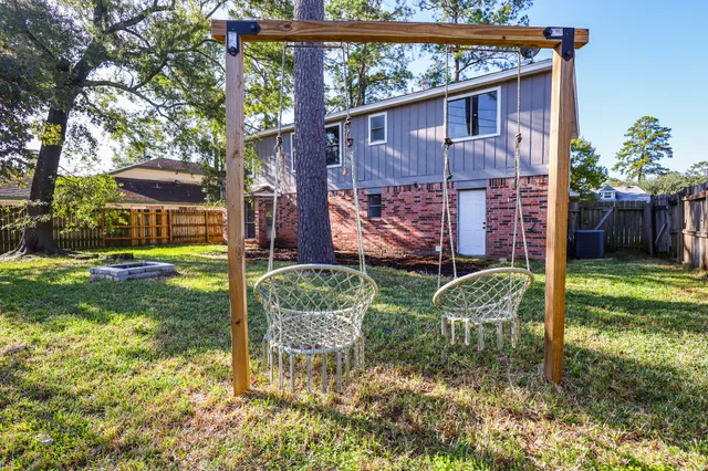 a view of backyard with potted plants and a large tree